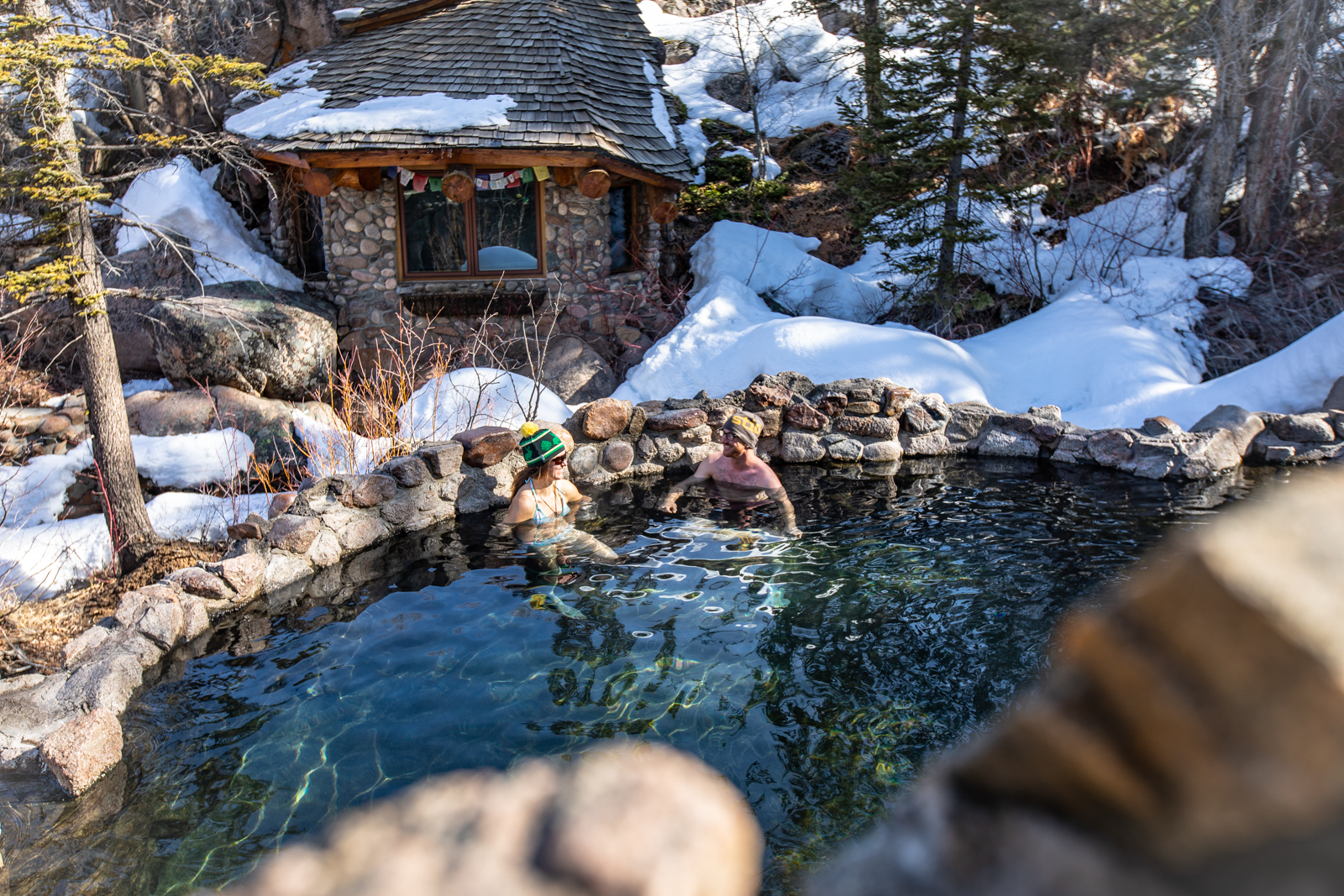 Soaking in a rustic hot tub under the snow