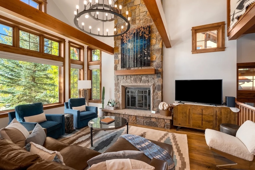 Bristlecone great room with vaulted beams and a stone fireplace
